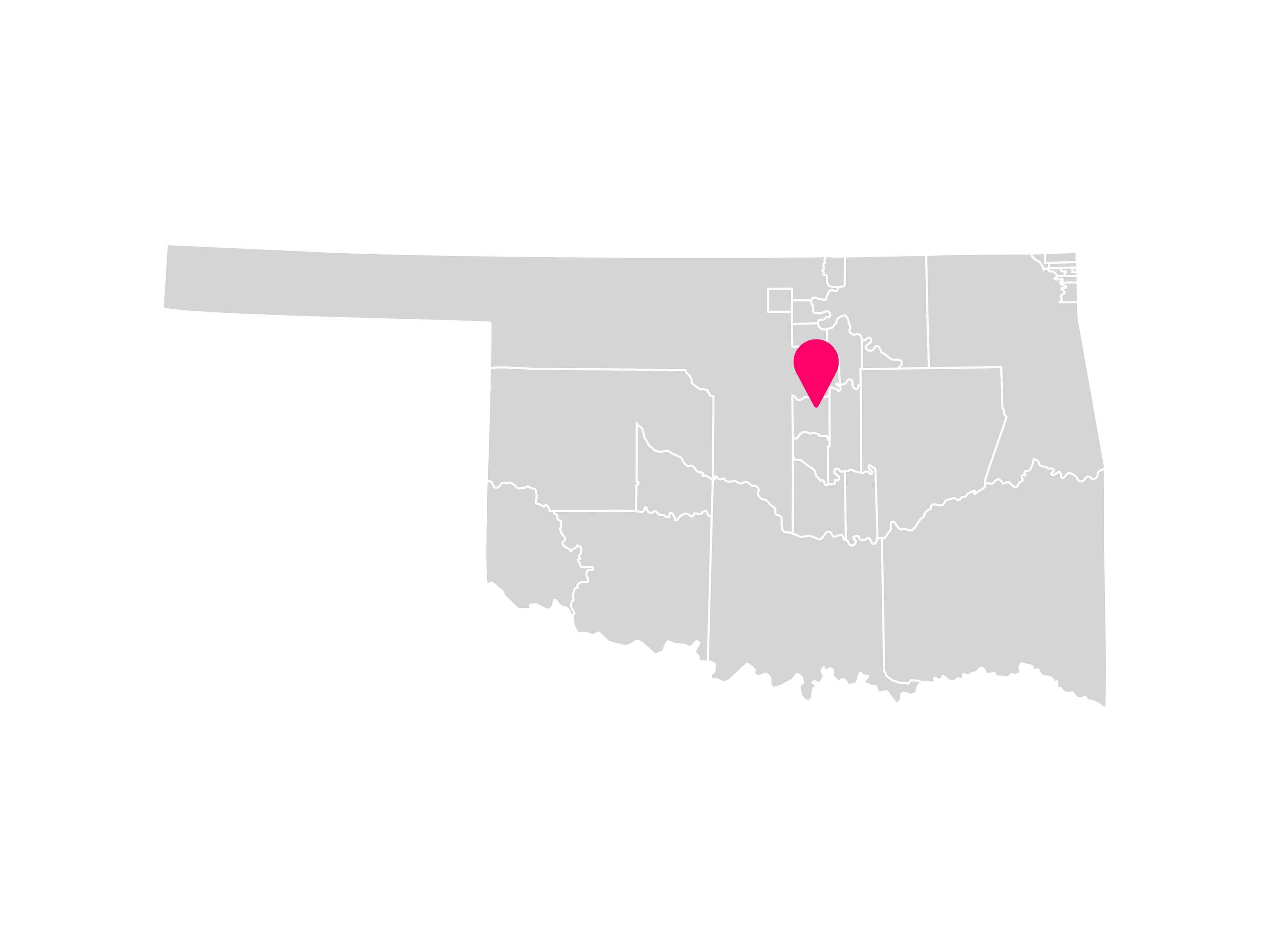 A gray map showing the tribal jurisdiction areas of Oklahoma with a pink pin marking Perkins, Oklahoma, where the Iowa Tribe of Oklahoma is headquartered.