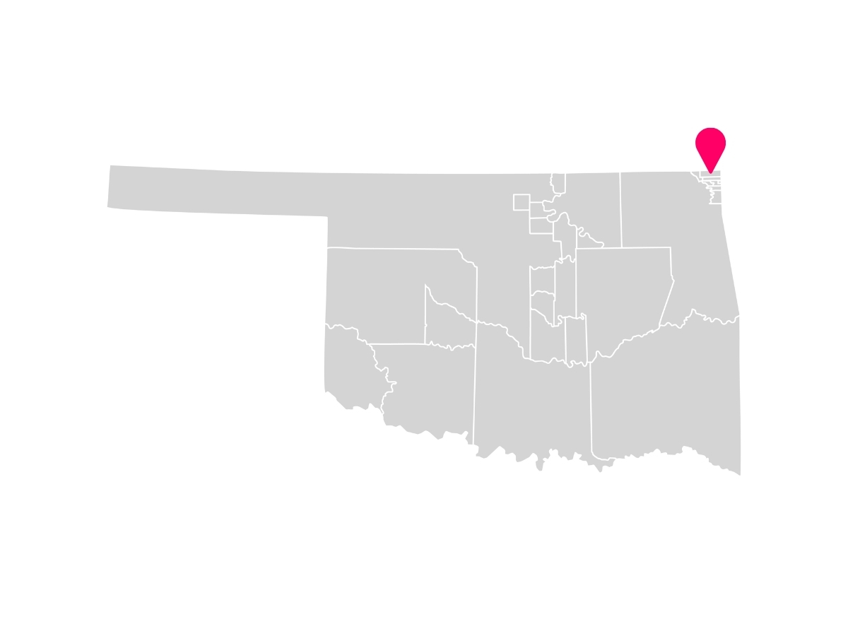 A gray map showing the tribal jurisdiction areas of Oklahoma with a pink pin marking Quapaw, Oklahoma, where the Quapaw Nation is headquartered.