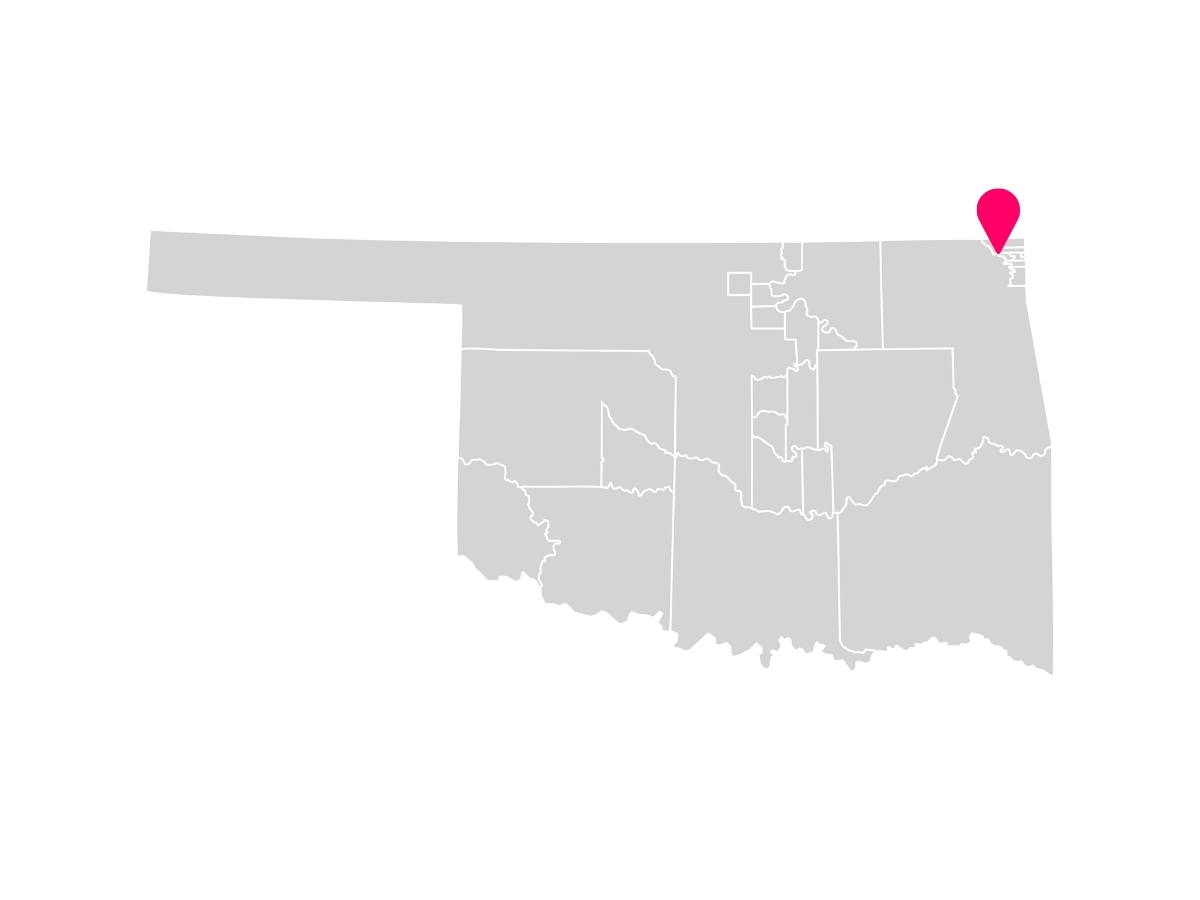 A gray map showing the tribal jurisdiction areas of Oklahoma with a pink pin marking Miami, Oklahoma, where the Ottawa Tribe of Oklahoma is headquartered.