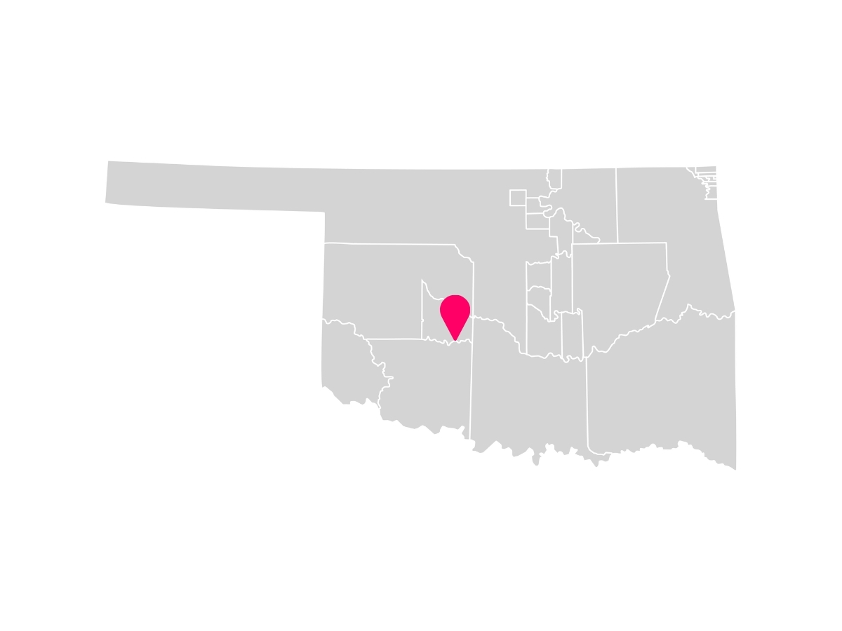 A gray map showing the tribal jurisdiction areas of Oklahoma with a pink pin marking Anadarko, Oklahoma, where the Wichita & Affiliated Tribes are headquartered.