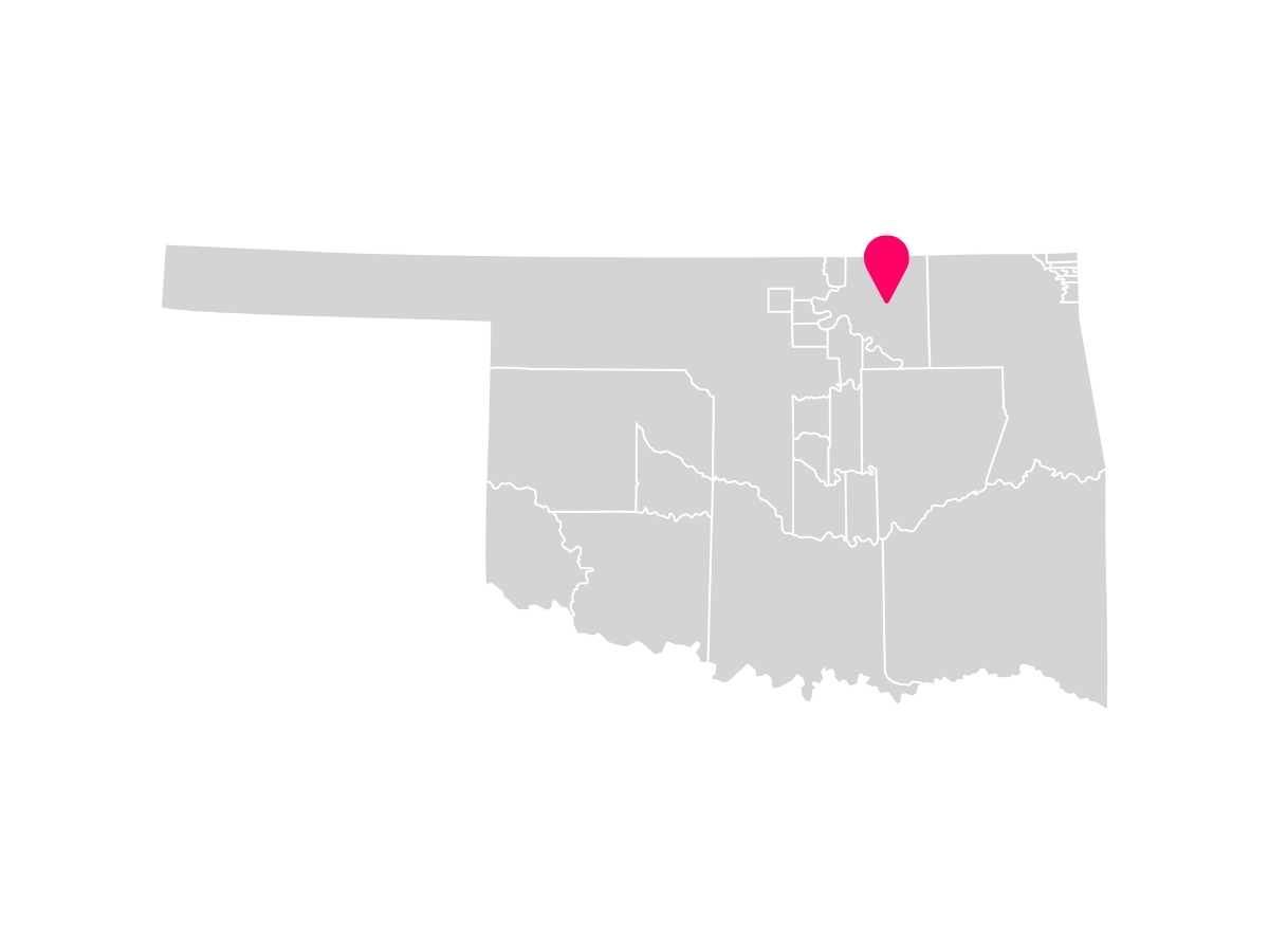A gray map showing the tribal jurisdiction areas of Oklahoma with a pink pin marking Pawhuska, Oklahoma, where the Osage Nation is headquartered.