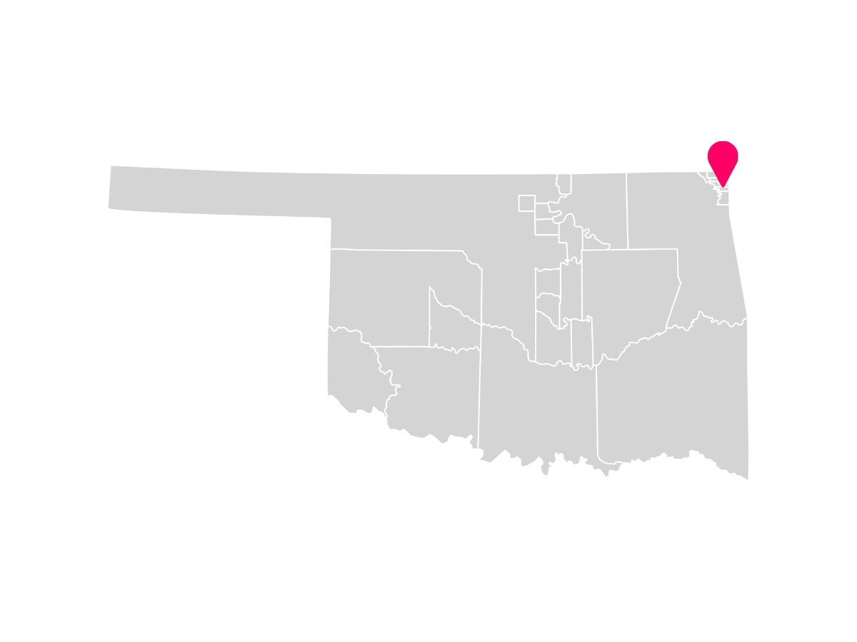 A gray map showing the tribal jurisdiction areas of Oklahoma with a pink pin marking Wyandotte, Oklahoma, where the Wyandotte Nation is headquartered.