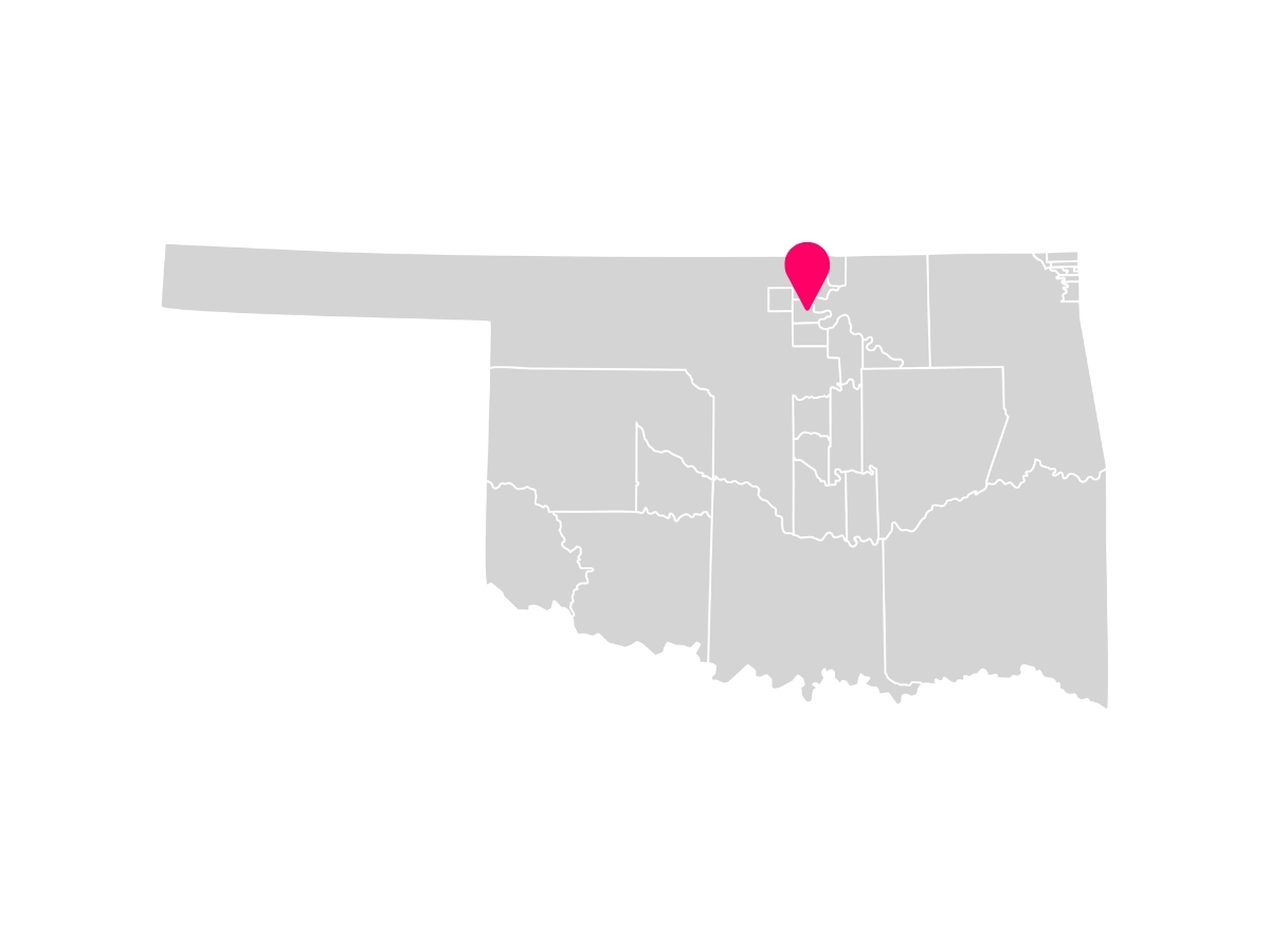 A gray map showing the tribal jurisdiction areas of Oklahoma with a pink pin marking Ponca City, Oklahoma, where the Ponca Tribe of Indians of Oklahoma is headquartered.