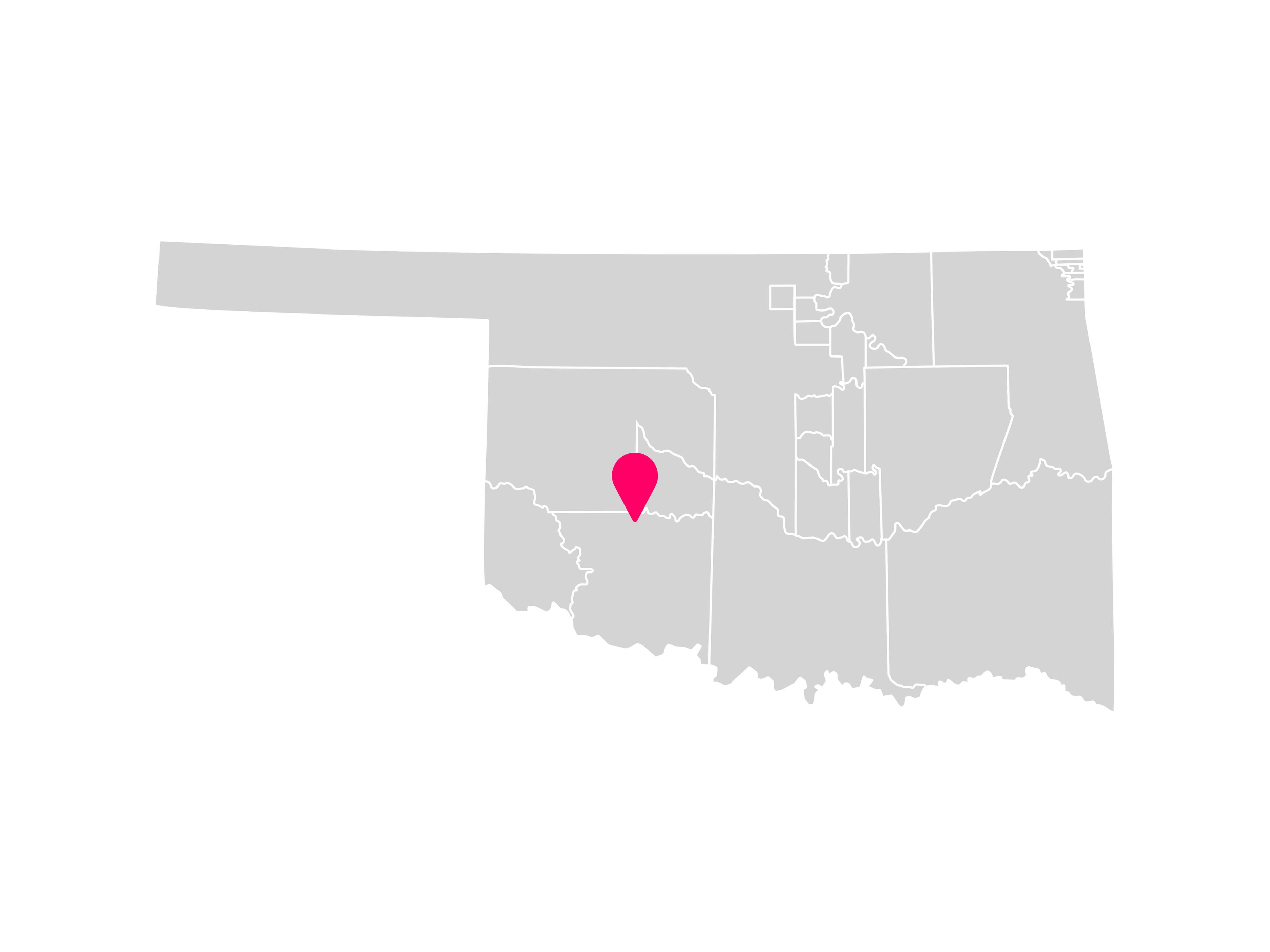 A gray map showing the tribal jurisdiction areas of Oklahoma with a pink pin marking Carnegie, Oklahoma, where the Kiowa Tribe is headquartered.