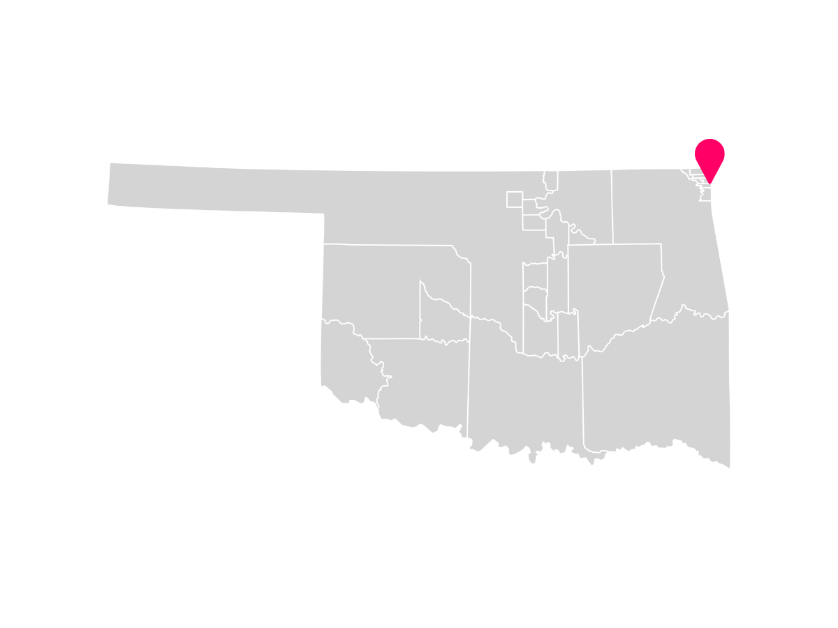 A gray map showing the tribal jurisdiction areas of Oklahoma with a pink pin marking Seneca, Oklahoma, where the Eastern Shawnee Tribe of Oklahoma is headquartered.